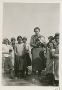 Image: Miriam MacMillan with Eskimo [Inuit] puppy and school children